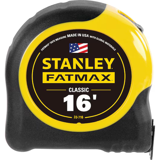The STANLEY® FATMAX® 16 ft x 1.25 in Tape Rule is a professional-grade measuring tool with a yellow and black case, made in the USA with global materials, featuring an American flag to highlight its quality craftsmanship.